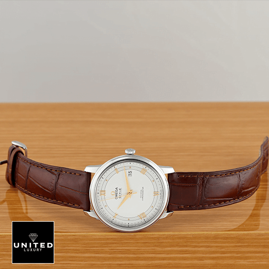 Omega De Ville Prestige 434.13.41.21.03.001 "Blue Dial" Supreme Copy 1:1 omega de ville prestige 424 13 40 20 02 002 side front Omega De Ville Prestige White Dial Brown Leather Bracelet Replica on the table